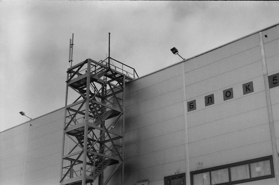 Industrial building with a steel stair tower, in black and white